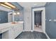 Bathroom with vanity, mirror, lighting, and a toilet and shower view in the adjacent room at 3418 Braeside Pl, Clearwater, FL 33759