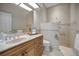 Neutral bath featuring a marble vanity, tile flooring, walk-in shower and updated fixtures at 3418 Braeside Pl, Clearwater, FL 33759