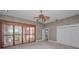 Bedroom featuring shuttered windows, neutral color scheme, ceiling fan, closet and ensuite bathroom at 3418 Braeside Pl, Clearwater, FL 33759