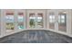 Bright bedroom with multiple French doors leading to a waterfront view with a pool at 3418 Braeside Pl, Clearwater, FL 33759