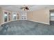 Bright bedroom with neutral tones and multiple doors leading to a waterfront view at 3418 Braeside Pl, Clearwater, FL 33759
