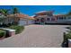 Elegant Mediterranean-style home boasting a spacious brick driveway and three-car garage at 3418 Braeside Pl, Clearwater, FL 33759