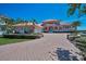 Lovely property with clay tile roof, circular driveway, and professionally landscaped yard at 3418 Braeside Pl, Clearwater, FL 33759