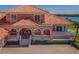 Elegant exterior featuring a clay tile roof, arched entryway, and manicured landscaping at 3418 Braeside Pl, Clearwater, FL 33759