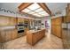 Spacious kitchen with a center island, tiled floors, and built-in appliances at 3418 Braeside Pl, Clearwater, FL 33759