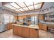 Updated kitchen boasts stainless steel appliances, granite counters, and large center island at 3418 Braeside Pl, Clearwater, FL 33759