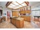 Open kitchen with an island, pendant lighting, and views of the adjacent Gathering room and pool table at 3418 Braeside Pl, Clearwater, FL 33759