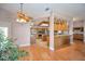 Open-concept living space showcasing hardwood floors, ceiling fan, and kitchen with island at 3418 Braeside Pl, Clearwater, FL 33759
