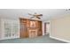 Inviting living room showcasing a brick fireplace, custom shelving, and window with plantation shutters at 3418 Braeside Pl, Clearwater, FL 33759