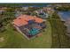 Aerial view of screened in pool and lanai with view of the waterfront at 3418 Braeside Pl, Clearwater, FL 33759