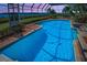 Inviting screened pool and spa offer a refreshing escape with a beautiful waterfront view at 3418 Braeside Pl, Clearwater, FL 33759