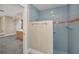 Tiled shower is the bathroom featuring blue and pink tiles with a brass towel bar and shower head at 3418 Braeside Pl, Clearwater, FL 33759