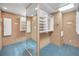 Spacious walk-in closet with shelving and ample storage solutions and carpeted floors at 3418 Braeside Pl, Clearwater, FL 33759