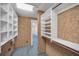 Bright walk-in closet with carpeted floors, shelving, and a view of the hallway and rooms at 3418 Braeside Pl, Clearwater, FL 33759