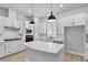 Modern kitchen with white cabinets, quartz countertops, and an island at 444 31St N St, St Petersburg, FL 33713