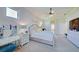 Bright main bedroom with vanity and large TV at 13267 Linzia Ln, Spring Hill, FL 34609