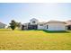 Large backyard with a view of the home's exterior at 13267 Linzia Ln, Spring Hill, FL 34609