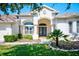 House exterior with a two-car garage and nicely landscaped front at 13267 Linzia Ln, Spring Hill, FL 34609