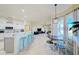 Modern kitchen with island seating and view to living room at 13267 Linzia Ln, Spring Hill, FL 34609