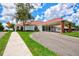 Community clubhouse exterior with circular driveway and landscaping at 13267 Linzia Ln, Spring Hill, FL 34609