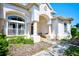 Front entryway with columns and decorative landscaping at 13267 Linzia Ln, Spring Hill, FL 34609