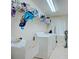 Bright laundry room, washer, dryer, utility sink, and ample shelving at 13267 Linzia Ln, Spring Hill, FL 34609