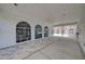Covered walkway with tiled flooring and arched windows at 13267 Linzia Ln, Spring Hill, FL 34609