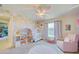 Bedroom with crib, armchair, and dollhouse at 13267 Linzia Ln, Spring Hill, FL 34609