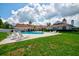 Community pool with lounge chairs and a clubhouse at 13267 Linzia Ln, Spring Hill, FL 34609