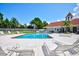 Community pool area with lounge chairs and clubhouse in background at 13267 Linzia Ln, Spring Hill, FL 34609