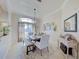 Bright dining room features a rustic table, bench seating, and an elegant chandelier at 13267 Linzia Ln, Spring Hill, FL 34609
