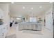 Open kitchen with island, stainless steel appliances, and view to living room at 13267 Linzia Ln, Spring Hill, FL 34609