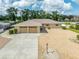 Single-story home with two-car garage and gravel driveway at 1230 W Del Webb Blvd, Sun City Center, FL 33573