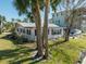 Single story home with canal view and palm trees at 11480 4Th E St, Treasure Island, FL 33706