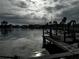 Wooden dock on calm water under a cloudy sky at 11480 4Th E St, Treasure Island, FL 33706