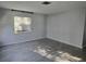 Living room featuring grey wood-look tile flooring and a large window at 1811 Michigan Ne Ave, St Petersburg, FL 33703