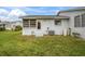 Private back patio with exterior access and AC unit at 12400 Dearborn Dr # F, Hudson, FL 34667