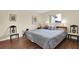Spacious bedroom with a king-size bed and wood flooring at 12400 Dearborn Dr # F, Hudson, FL 34667