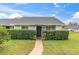 Inviting condo exterior with well-manicured lawn and walkway at 12400 Dearborn Dr # F, Hudson, FL 34667