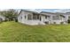 Exterior view of the house showcasing a sunroom and green lawn at 12400 Dearborn Dr # F, Hudson, FL 34667