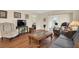 Comfortable living room with hardwood floors and views of the bedroom and patio at 12400 Dearborn Dr # F, Hudson, FL 34667