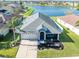 Aerial view of a one-story house near a lake, showcasing its curb appeal at 1810 Raven Glen Dr, Ruskin, FL 33570