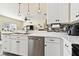 Kitchen features stainless steel dishwasher and white cabinets at 724 Griffen Heights Ct, Ruskin, FL 33570