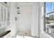 Bright white tiled shower with a white curtain at 303 W North Bay St, Tampa, FL 33603