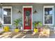 Inviting front porch with red door, plants, and seating at 303 W North Bay St, Tampa, FL 33603