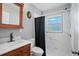 Updated bathroom with a shower/tub combo and modern vanity at 9029 109Th Ave, Seminole, FL 33777