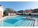 Community pool with lounge chairs and umbrellas; resort-style amenities at 10038 Corso Milano Dr, Tampa, FL 33625