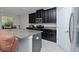 Modern kitchen with dark cabinets and granite island at 10038 Corso Milano Dr, Tampa, FL 33625