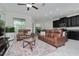 Spacious living room with leather sofas and a large TV at 10038 Corso Milano Dr, Tampa, FL 33625