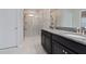 Double vanity bathroom with granite countertop and walk-in shower at 10038 Corso Milano Dr, Tampa, FL 33625